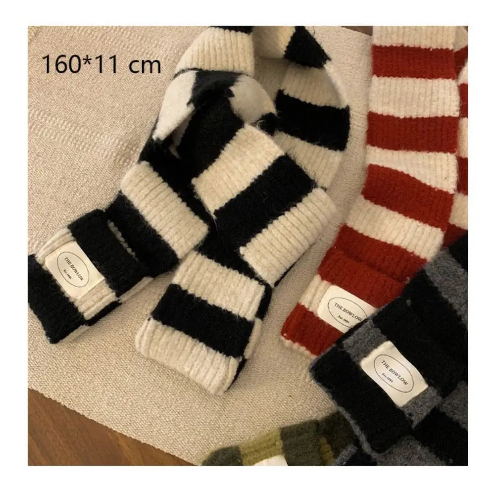 Striped shawl scarf layered over winter coat