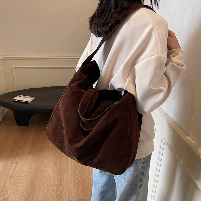 Suede tote bag worn crossbody style