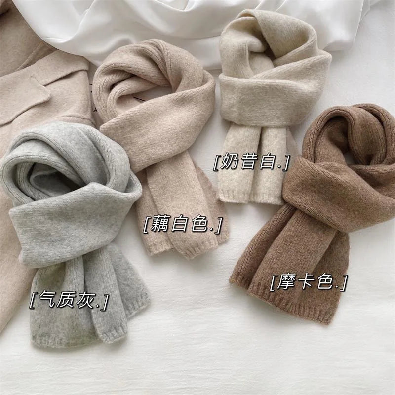 Person wearing solid color knit winter scarf