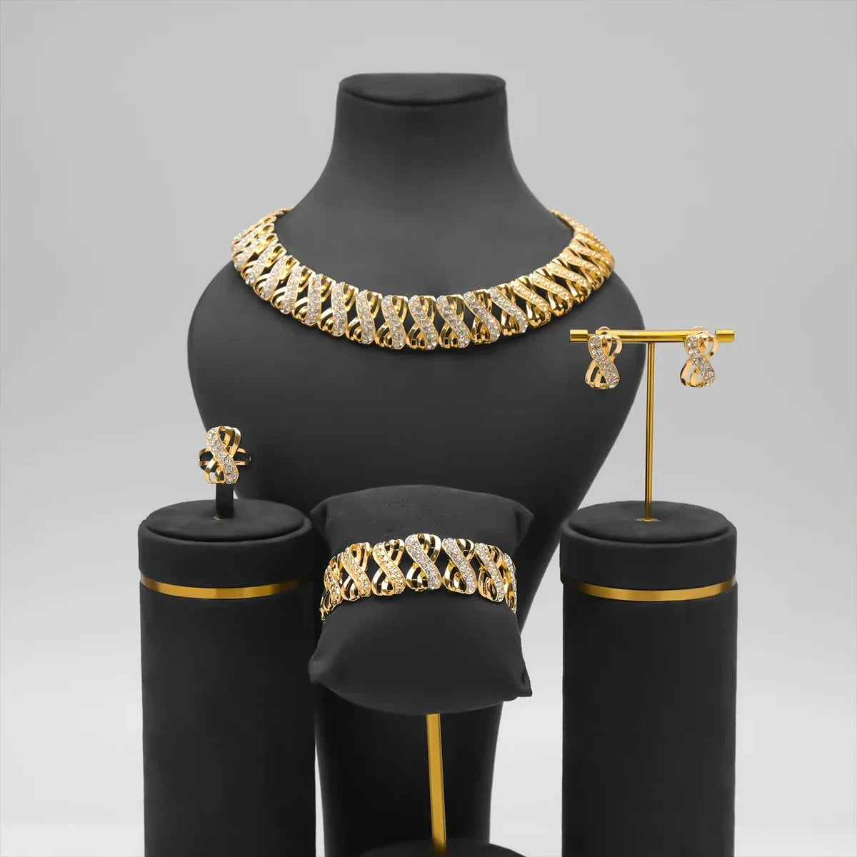 Close-up of gold-tone necklace and earrings from jewelry set