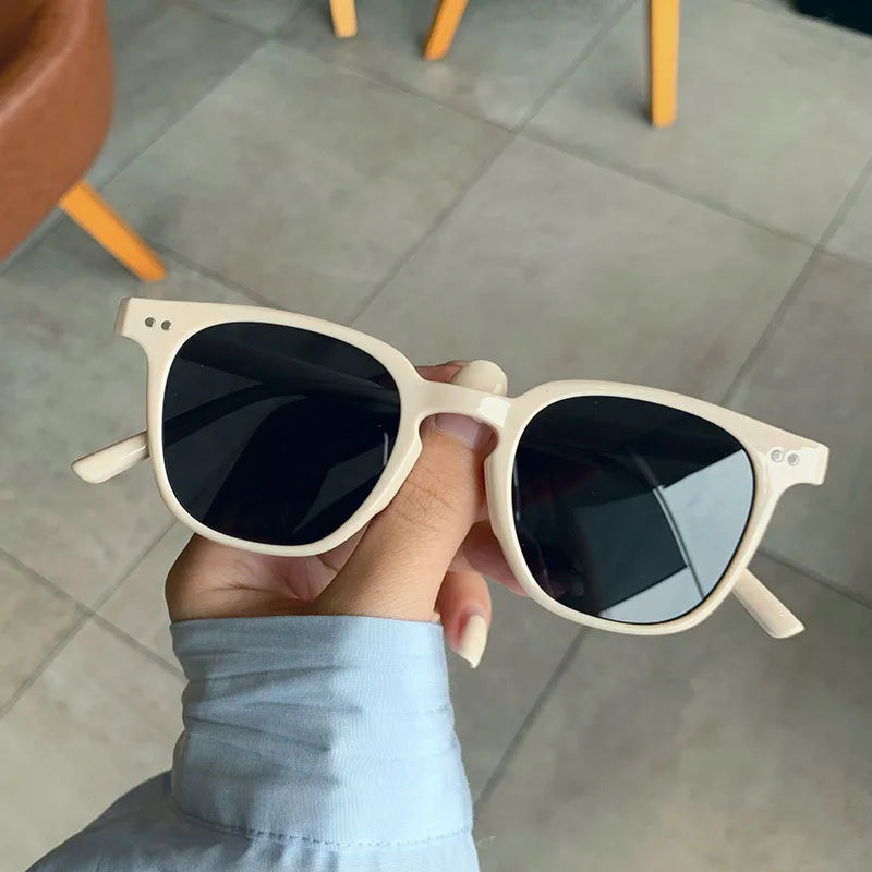 Model wearing vintage square sunglasses outdoors