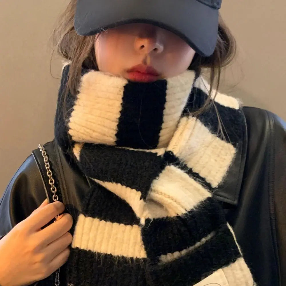 Person wearing striped shawl wrap scarf